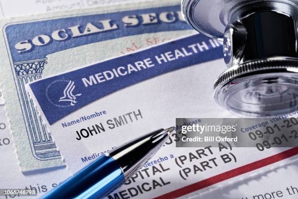 THE SEA RANCH, CALIFORNIA - November 12, 2018: Medicare Health Insurance and Social Security card on medical report with stethoscope. Medicare is a national health insurance program provided by the United States for seniors 65 and older.  Social Security is a federal insurance program that gives benefits to retired, unemployed and disabled people.